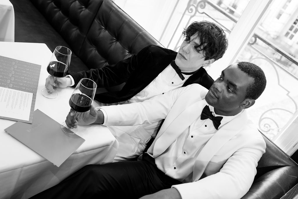 Queer couple drinking wine at Bacchus MKE wedding