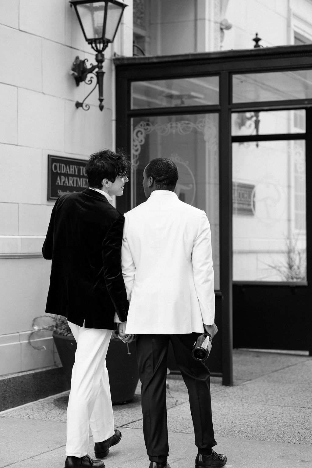 LGBTQ+ married couple holding hands outside Bacchus in Milwaukee, WI