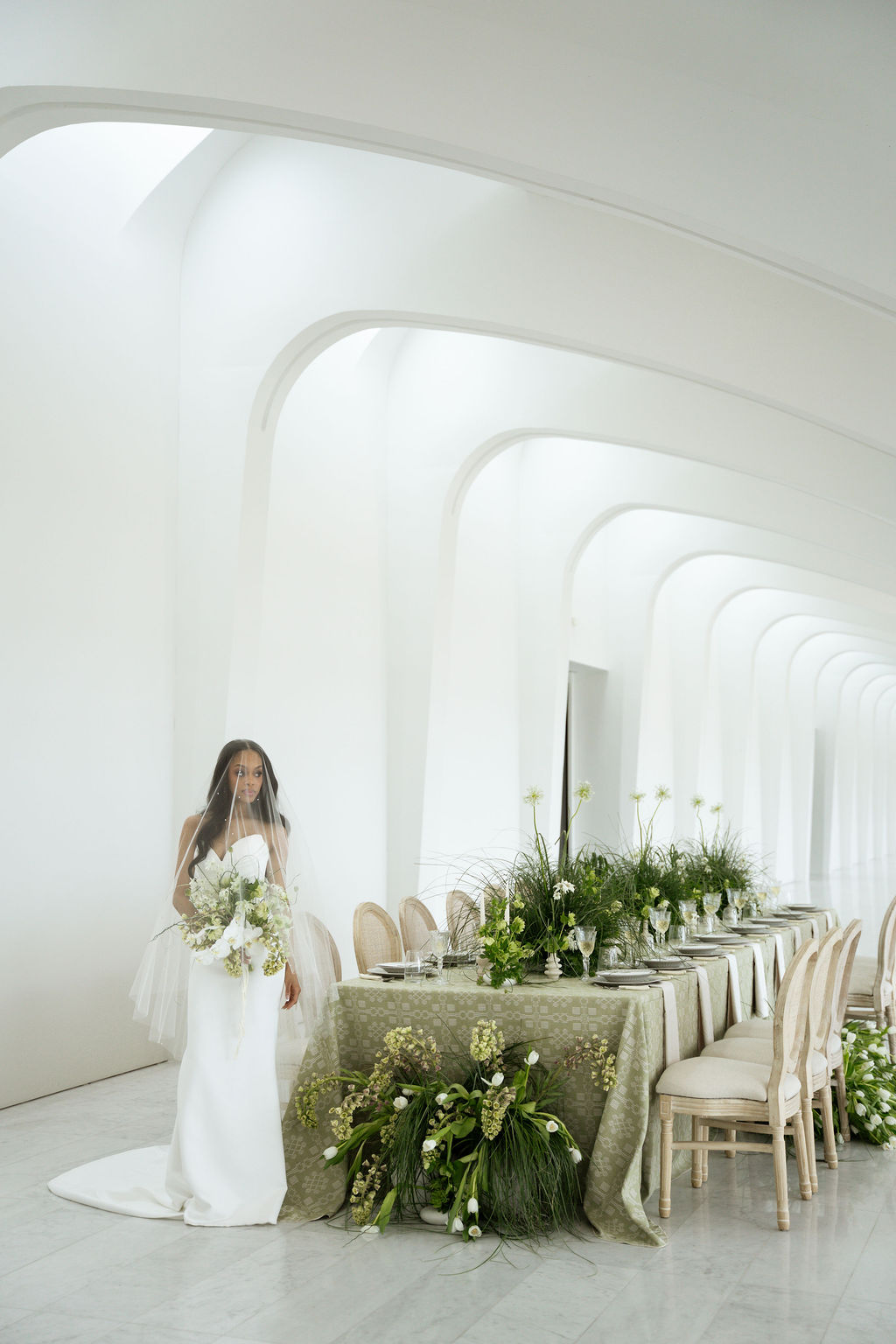 bride standing next to wedding tablescape at MAM wedding