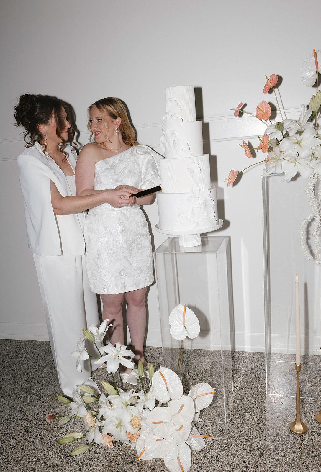 Brides cutting wedding cake at Denizen in Milwaukee, WI