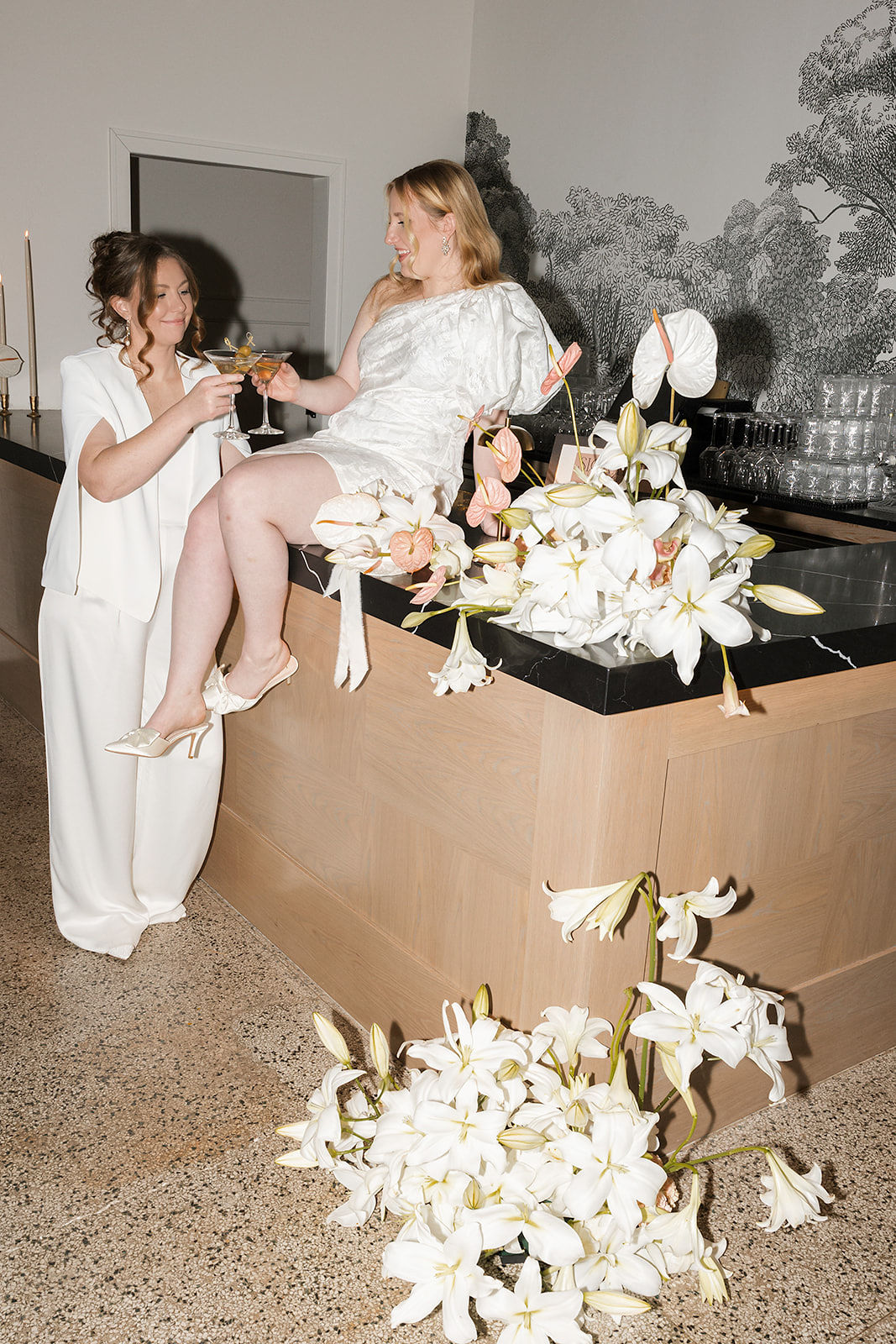 Brides toasting at wedding cocktail hour at Denizen in Milwaukee, WI
